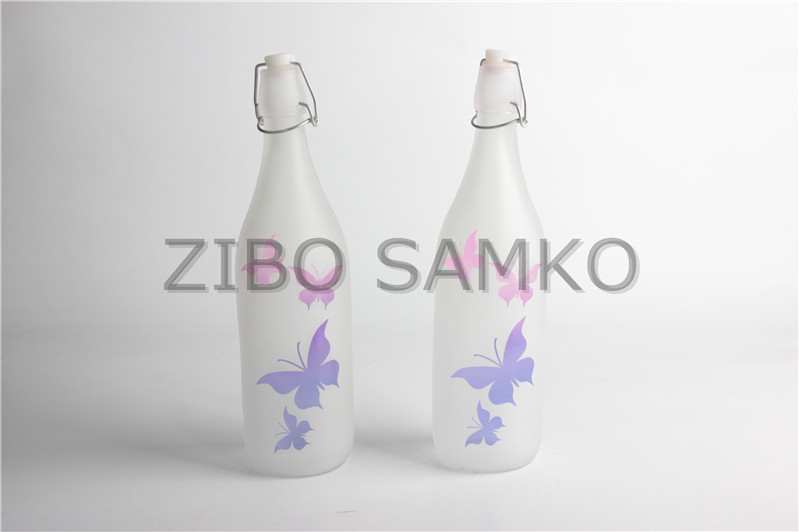 Glass bottle with butterfly design